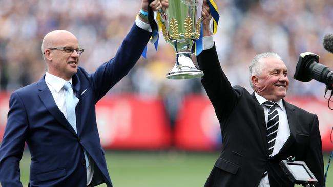 Tony Shaw, right, holds the AFL premiership cup prior to the 2018 Grand Final.