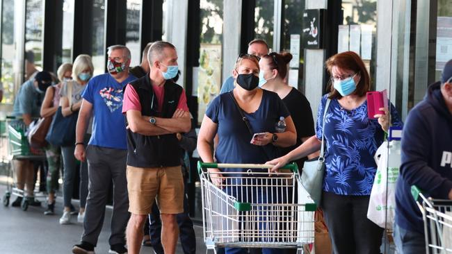 Shoppers queue at the Racecourse Road Woolworths in Ascot. Picture: David Clarkies