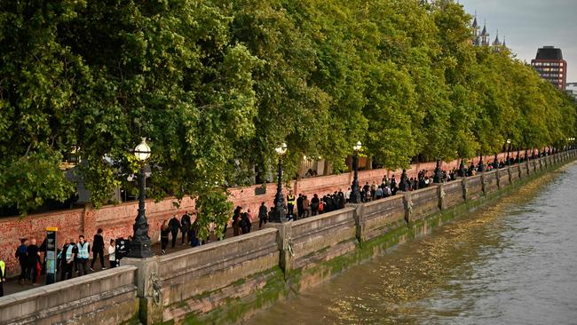 Members of the public queue on the embankment between Westminster and Lambeth Bridge. Picture: AFP.