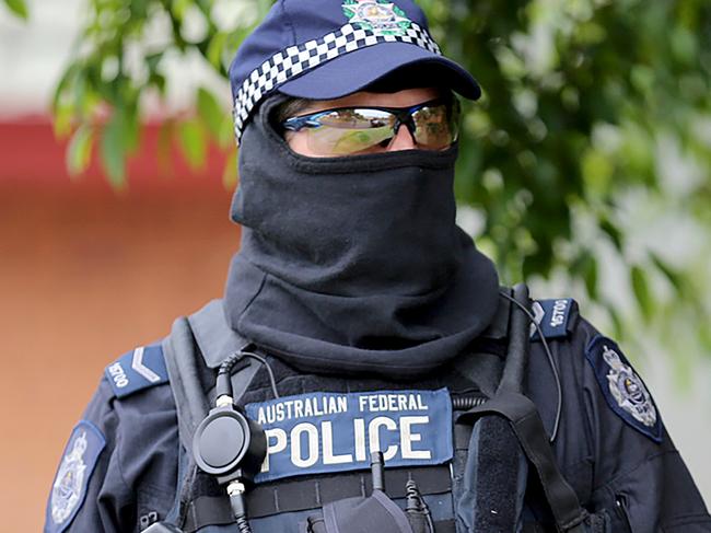 This handout photo taken and released by the New South Wales Police on December 10, 2015 shows an Australian Federal Police (AFP) officer during a counter-terrorism operation in Sydney. Two people, including a 15-year-old boy, were arrested on December 10 in Sydney over a terror plot targeting a government building, with authorities expressing alarm at the age of those being radicalised. AFP PHOTO / NEW SOUTH WALES POLICE -----EDITORS NOTE---- RESTRICTED TO EDITORIAL USE - MANDATORY CREDIT "AFP PHOTO / NEW SOUTH WALES POLICE" - NO MARKETING NO ADVERTISING CAMPAIGNS - DISTRIBUTED AS A SERVICE TO CLIENTS / AFP PHOTO / NEW SOUTH WALES POLICE / NEW SOUTH WALES POLICE