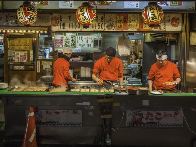 A street food market stall in the Dotonbori district of Osaka.