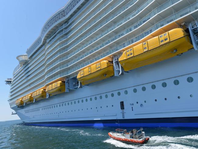 Lifeboats can be seen attached to the side of the Harmony of the Seas cruise ship as it sails from the STX Saint-Nazaire shipyard, western France. Picture: AFP/Jean-Francois Monier