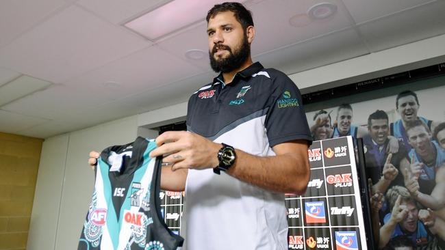 Port Adelaide ruckman Paddy Ryder holds the Sir Douglas Nicholls Indigenous Round guernsey at Alberton yesterday. Picture: AAP.