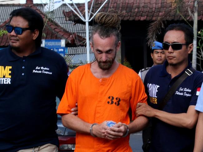 David Taylor is escorted by police back to his cell after meeting with British Consulate staff at Denpasar Police Station. David And Sara Connor were arrested on suspicion of being involved with the murder of a Balinese police officer on Kuta beach on August 17, 2016. Picture: Lukman S. Bintoro