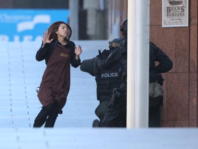 One of the hostages escapes the Lindt cafe. Picture: Adam Taylor