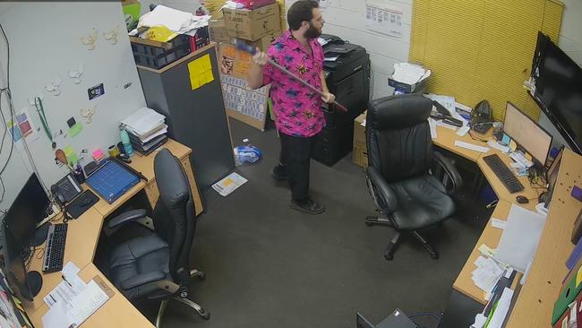 A staff member prepares to defend the building with a broom at the Katherine Country Club on the early hours of Monday morning. Picture: Supplied