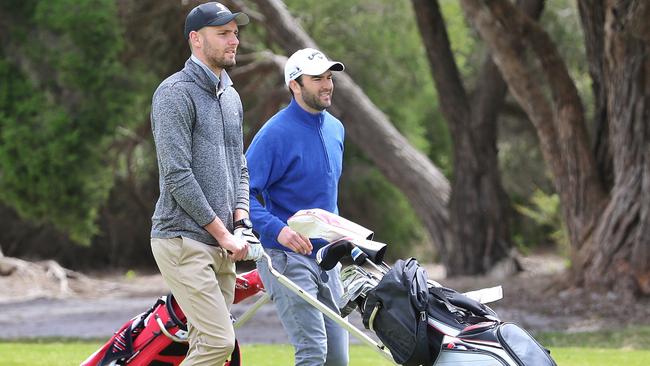 Jack Gunston (L) on the golf course with former teammate Jordan Lewis in 2016. Picture: Hamish Blair. 