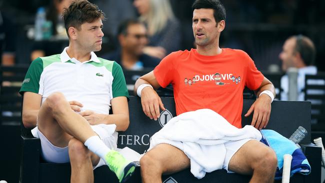 Filip Krajinovic of Serbia and Novak Djokovic chat after Novak took over Filips game against Jannik Sinner of Italy during the 'A Day at the Drive' exhibition tournament at Memorial Drive in ADelaide. Picture: Mark Brake/Getty Images