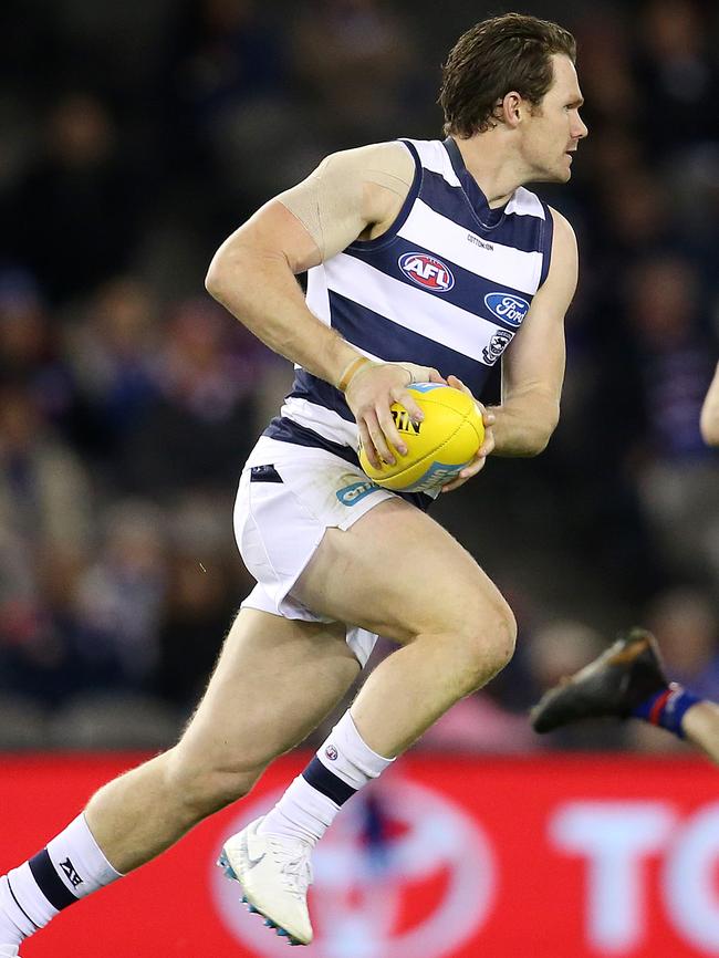 The boundary fence drew blood, but it didn’t slow Patrick Dangerfield down. Picture: Michael Klein