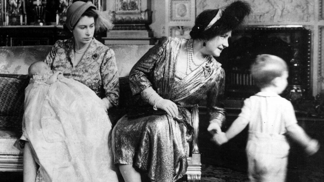 The Queen Mother tries to keep track of a nearly two-year old Prince Charles at the October 1950 christening of his sister Anne at Buckingham Palace. Born at Clarence House on August 15, Anne was later granted the title of Princess Royal.