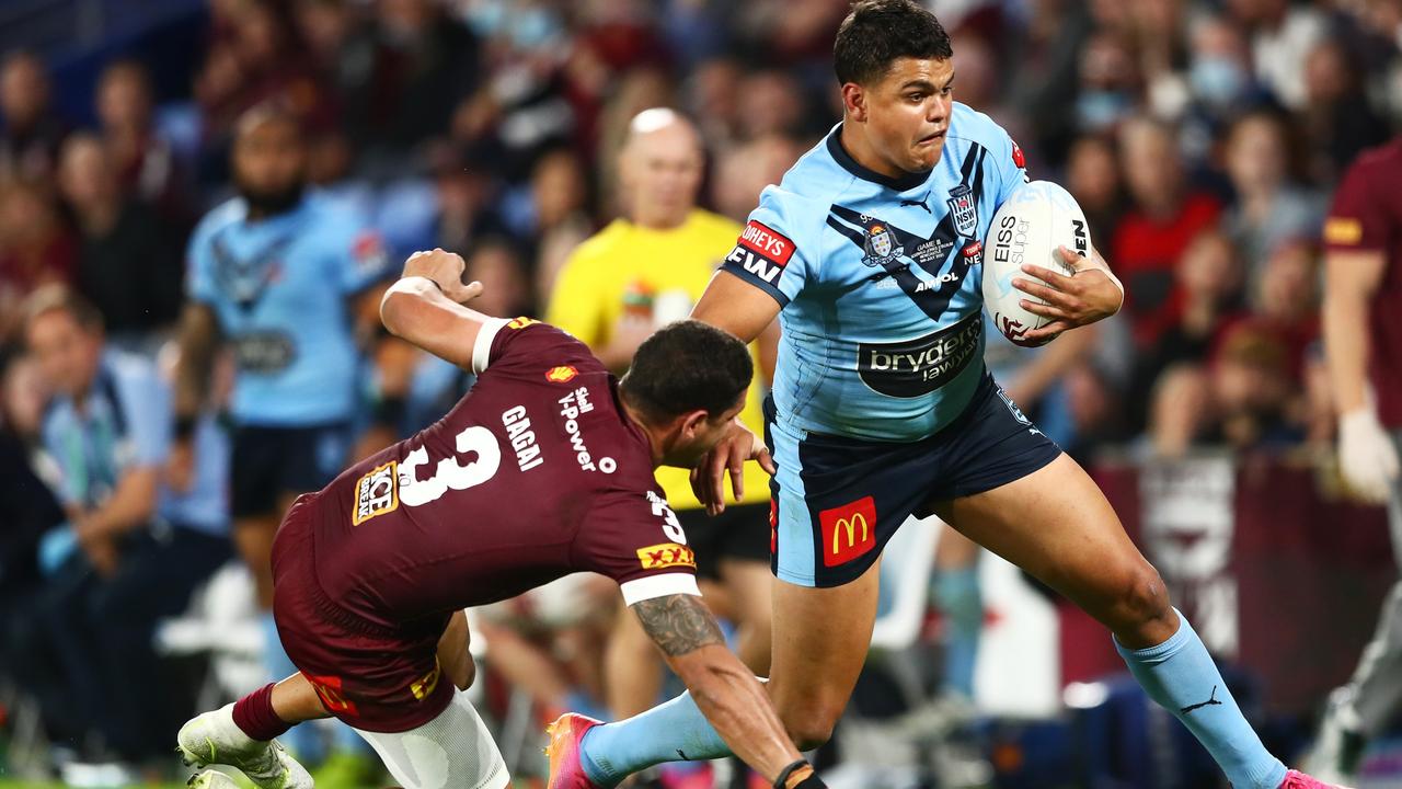 Latrell Mitchell puts a fend on Dane Gagai. Picture: Chris Hyde/Getty Images