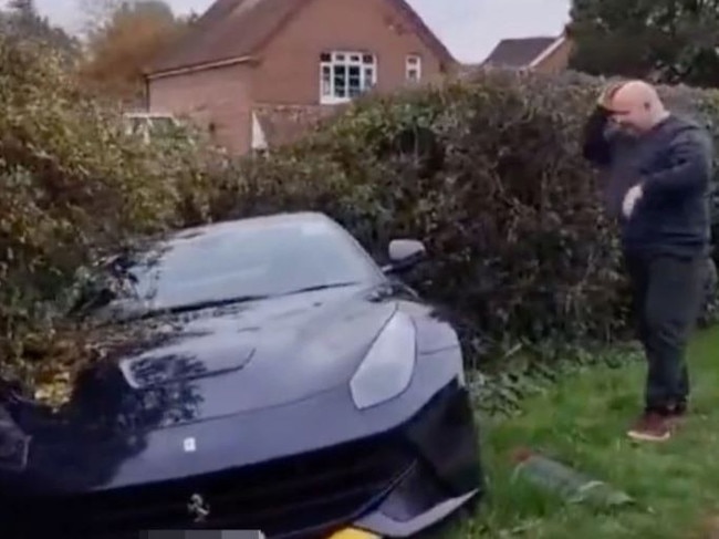 The man appears distraught at the crashed Ferarri. Picture: Twitter