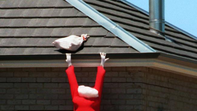 24Dec97 ' Caught in the act of trying to find an easier way into a Gisbourne home Santa Clause obliviously couldn't fit down the flue and went looking for an easier way PICTURE BRUCE POSTLE .   f/l/Christmas