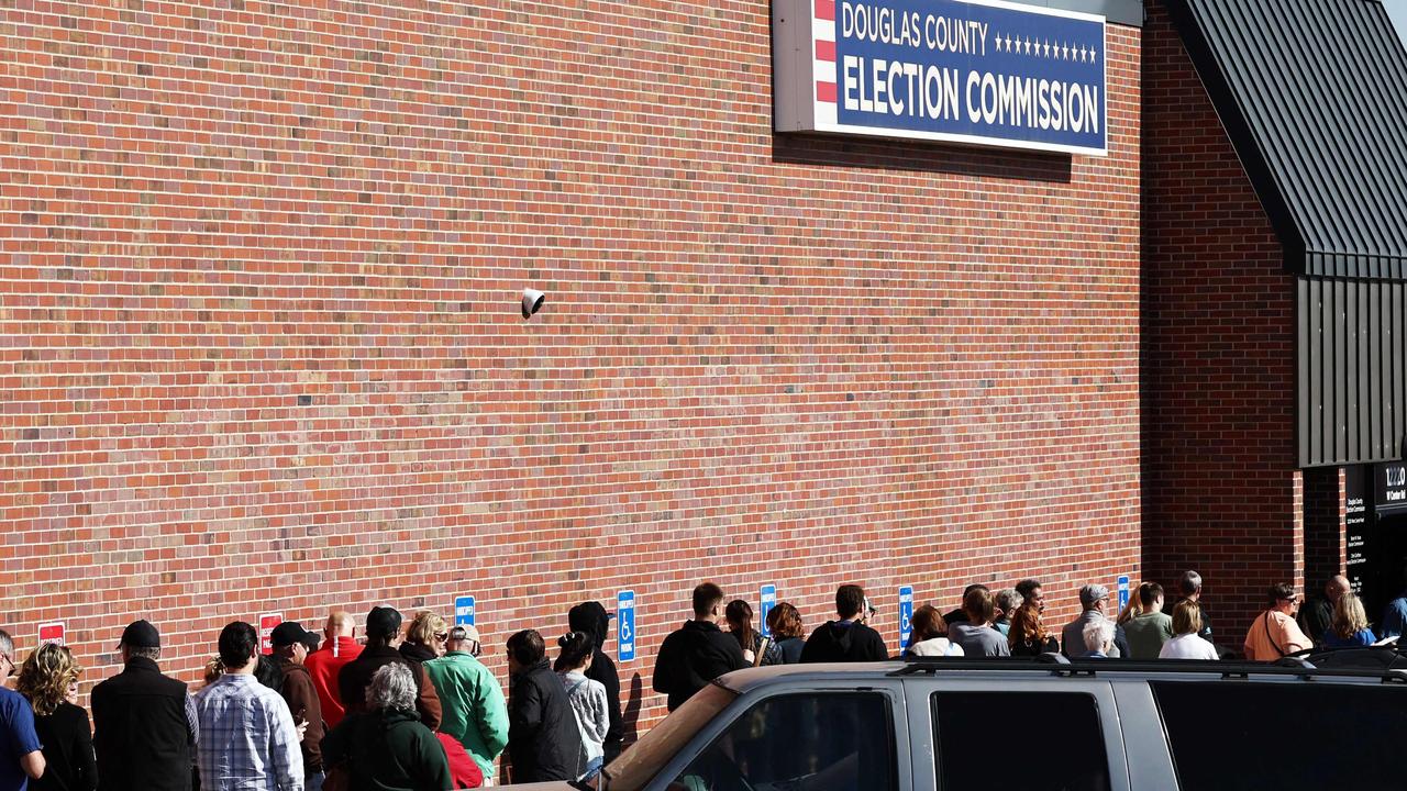 People wait in line to cast early ballots or register to vote outside the Douglas County Election Commission on October 24, 2024 in Omaha, Nebraska. (Photo by MARIO TAMA / GETTY IMAGES NORTH AMERICA / Getty Images via AFP)