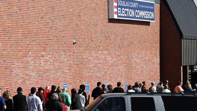 People wait in line to cast early ballots or register to vote outside the Douglas County Election Commission on October 24, 2024 in Omaha, Nebraska. (Photo by MARIO TAMA / GETTY IMAGES NORTH AMERICA / Getty Images via AFP)