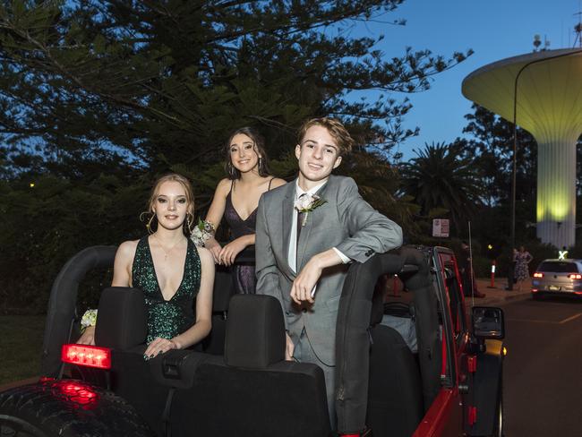 Arriving in the back of a Jeep are (from left) Emma Simons, Amy Moran and Ruben Toleman at Centenary Heights State High School formal at Picnic Point, Friday, November 20, 2020. Picture: Kevin Farmer