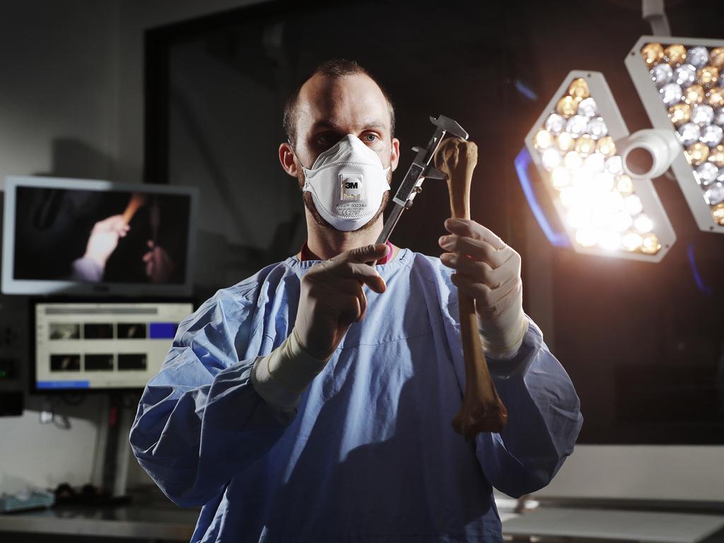 Dr Jack Garland, Forensic Pathologist at NSW Health Pathology Forensic and Analytical Science Service inspecting human remains. Picture: Sam Ruttyn