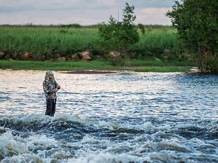 Fishermen brave the Shady Camp waters to catch the elusive barramundi during the start of the run off.