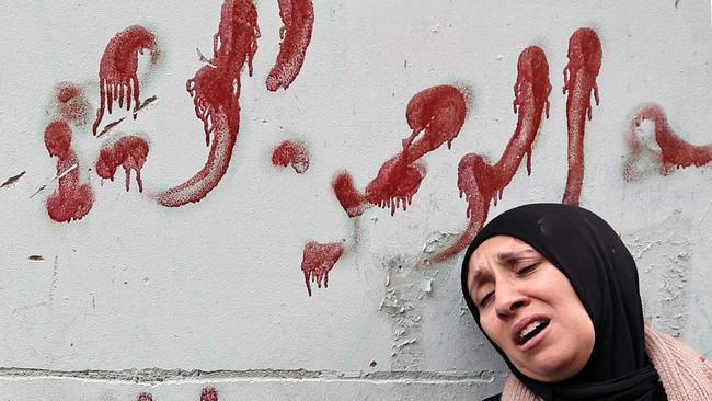 The mother of Muhammad Ayman Ghazawi and Basel Ayman Ghazawi, two of three Palestinian men killed in the raid on Ibn Sina hospital. Picture: AFP