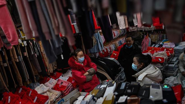 China, the country with the world’s biggest population and first initiator, now ranks 83rd on the list of virus cases. (Photo by Hector RETAMAL / AFP)