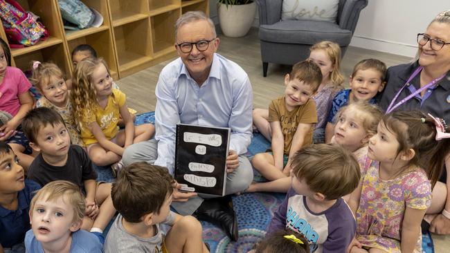 Prime Minister, Anthony Albanese reading to children a book they wrote for him at the Goodstart Early Learning Centre, Baringa. Picture: NewsWire/Sarah Marshall