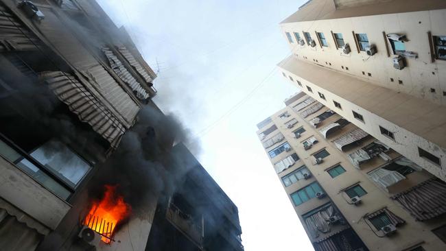 A fire burns in a damaged building at the site of overnight Israeli air strikes on the Chiah neighbourhood in Beirut’s southern suburbs on October 4, 2024. (Photo by Ibrahim AMRO / AFP)