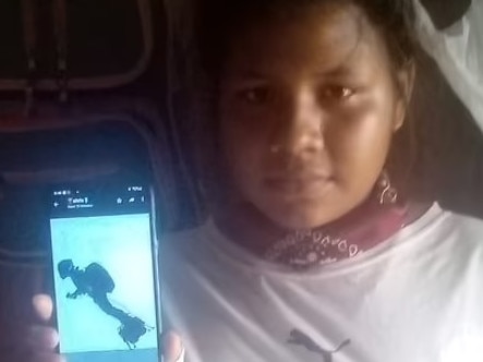 A local girl shows an image of the 'jetpacks' they saw. Picture: RPP