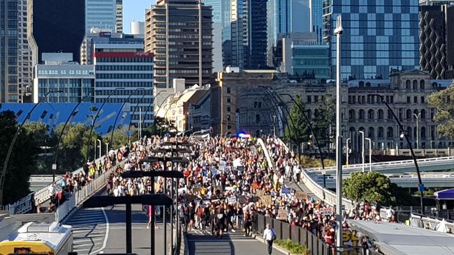 Black Lives Matter protesters march across Victoria Bridge in Brisbane.