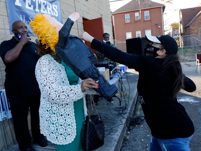 People smash a Donald Trump pinata as they celebrate Joe Biden’s win in Detroit, Michigan. Picture: AFP