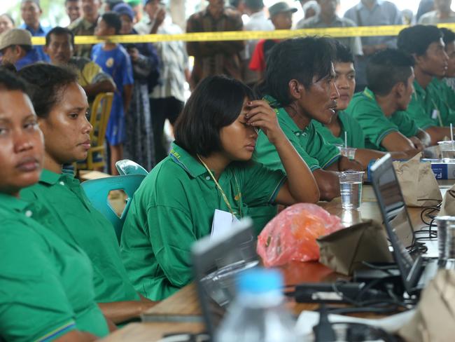 Survivors wait for identification at a police station. Picture: AFP / SEI LATIFA