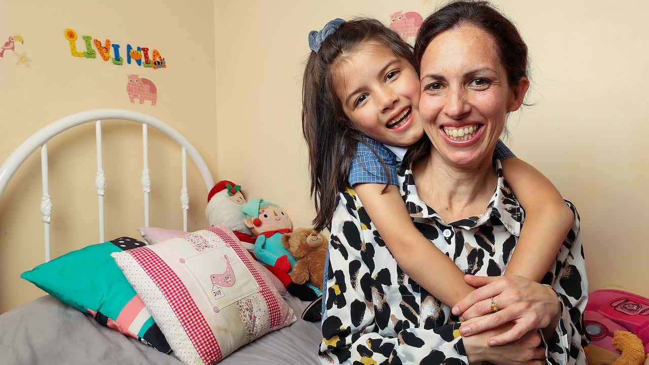 Livinia Buchan won the Kindergarten to Year 2 category for her story about how Covid-19 has changed hugs with her mum, Emma Maguire, who works in a hospital. Picture: Ian Currie