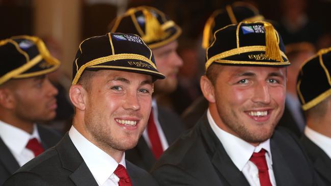 Mike Brown (L) and Sam Burgess of the England 2015 World Cup Rugby squad pose with their RWC cap at Sandhurst Millitary College for their official welcoming ceremony.