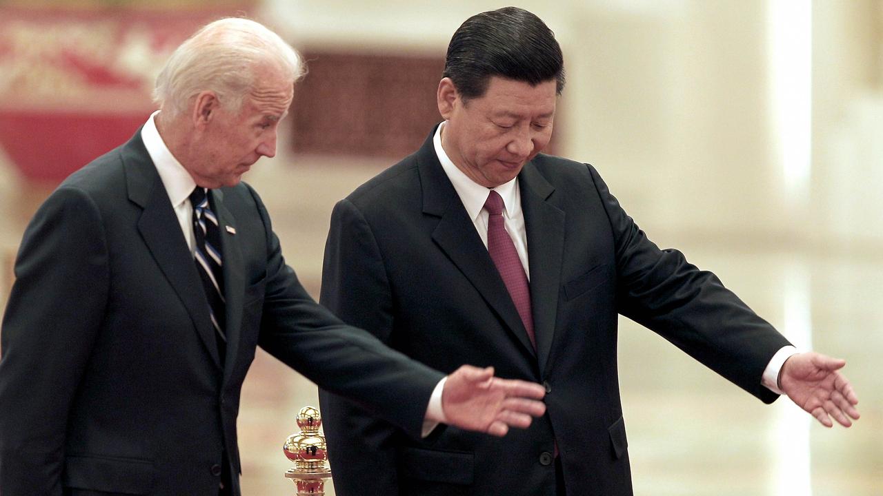 Then Chinese Vice President Xi Jinping invites then US Vice President Joe Biden to view an honour guard during a welcoming ceremony at the Great Hall in 2011.