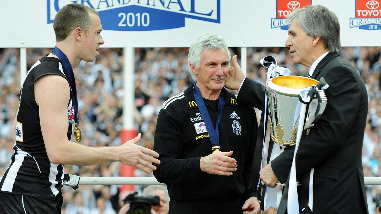 Collingwood legend Peter McKenna congratulates Mick Malthouse and Nick Maxwell after the 2010 grand final replay.