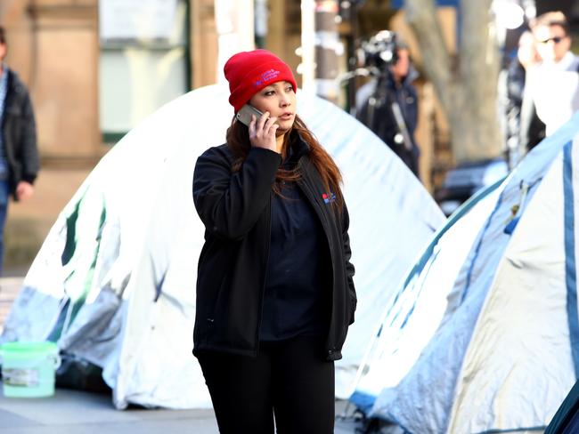 A housing services officer walks past the 'tent city' homeless camp in Sydney's Martin Place today. Picture: Hollie Adams/The Australian