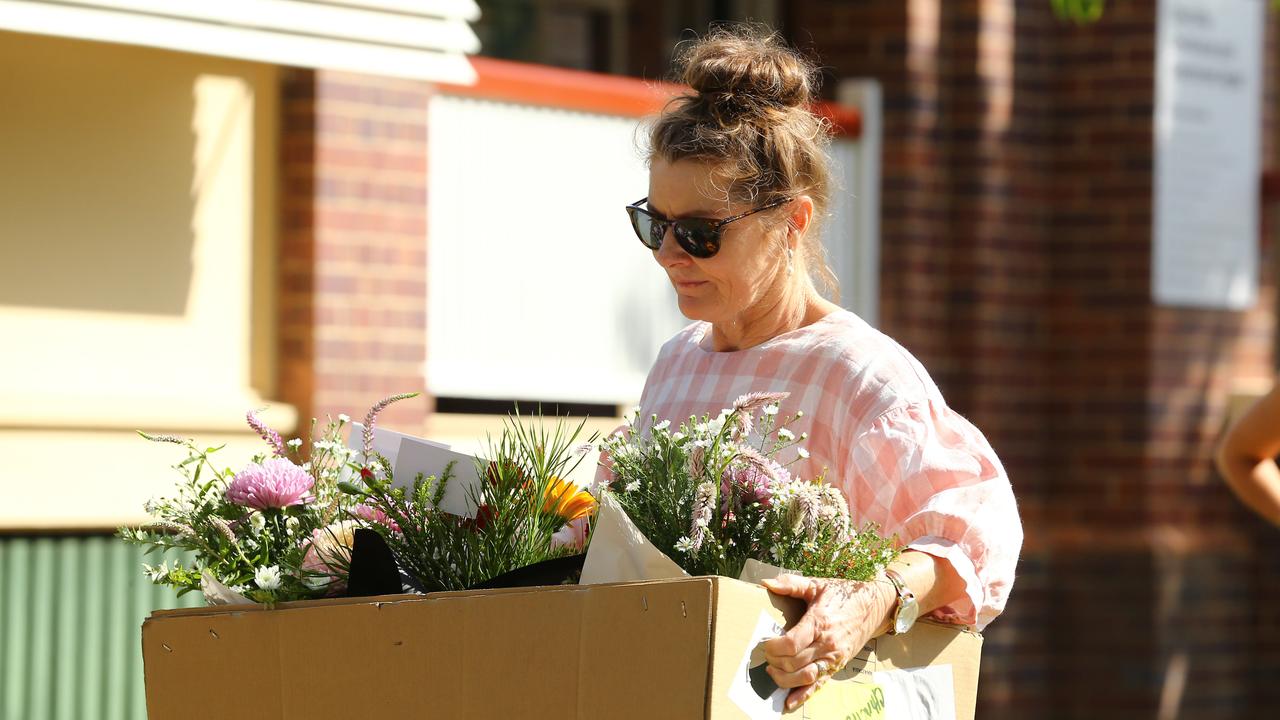 Chinchilla florist Erin Ford arrives with flowers honouring the two police officers. Picture: David Clark NCA/NewsWire