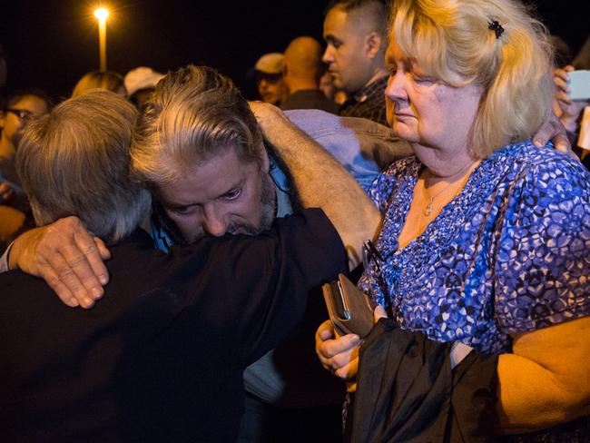 Ted and Ann Montgomery, employees at the First Baptist Church, are comforted by Texas Governor Greg Abbott. left. Picture: Suzanne Cordeiro/AFP