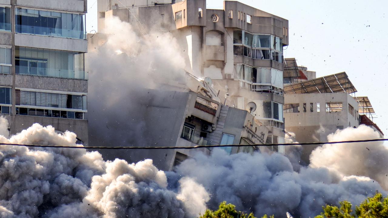 The moment a building collapses after an Israeli air strike on Beirut's southern Ghobeiry neighbourhood on November 15, 2024. (Photo by IBRAHIM AMRO / AFP)