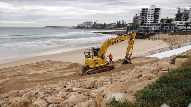 Workers at Cronulla Beach fill the sand area with rocks after huge swells caused massive erosion. Picture: Sam Ruttyn