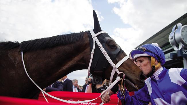 Jockey Hugh Bowman can’t resist stealing a kiss after the 2017 George Main. Picture: Sharon Lee Chapman