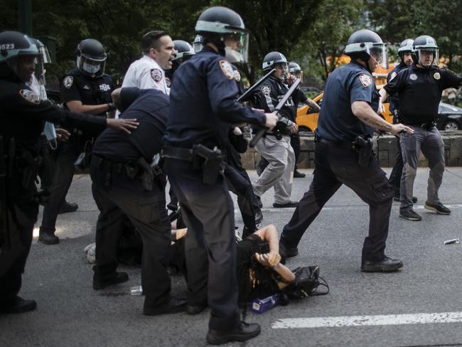 A protester falls to the ground in chaotic scenes in New York. Picture: AP