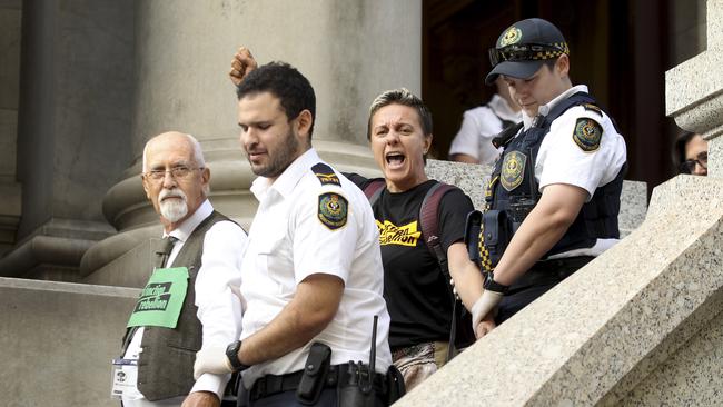 The protesters shouted and were cheered by supporters as they were removed. Picture Dean Martin