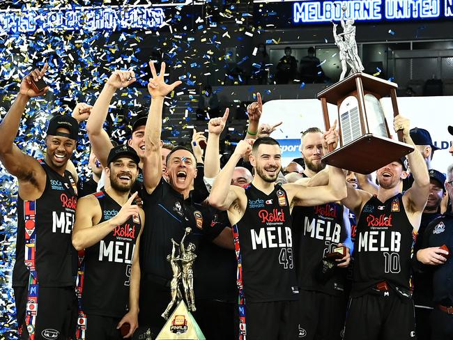 MELBOURNE, AUSTRALIA - JUNE 25:  The Melbourne United team celebrate victory with the trophy after game three of the NBL Grand Final Series between Melbourne United and the Perth Wildcats at John Cain Arena, on June 25, 2021, in Melbourne, Australia. (Photo by Quinn Rooney/Getty Images)