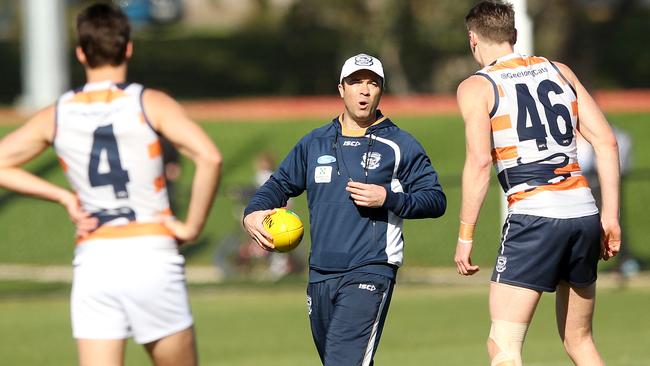 Cats coach Chris Scott talks to Mark Blicavs and Andrew Mackie during the session. Picture: Alison Wynd