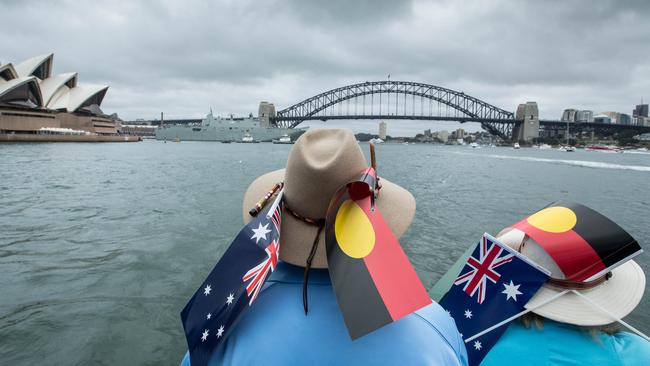 Participants wearing Australian and Aboriginal flags are seen aboard the ferry Emerald 6 during the annual Australia Day Ferrython on Sydney Harbour in 2018. Picture: AAP Image