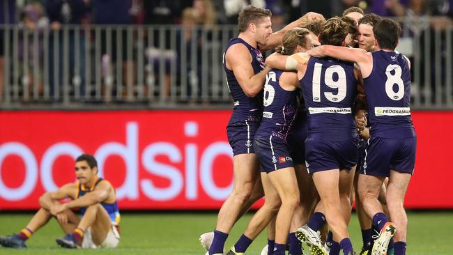 Fremantle players celebrate after Michael Walters’ after-the-siren behind delivered victory over the Lions. Picture: Getty