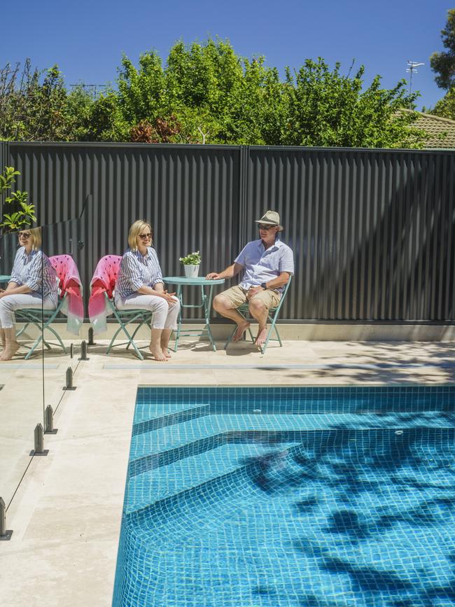 The Rutters relax beside their new pool family home. Picture: Nick Clayton.