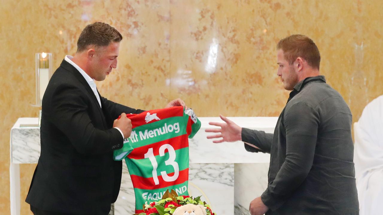 Sam and George Burgess placed the number 13 jersey worn last week on Sattler's coffin. Picture Glenn Hampson