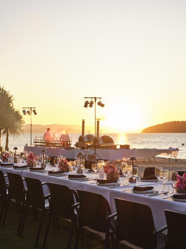 The sun sets behind the table settings for Saturday night's HIRW welcome dinner hosted at Qualia. Picture: Hamilton Island