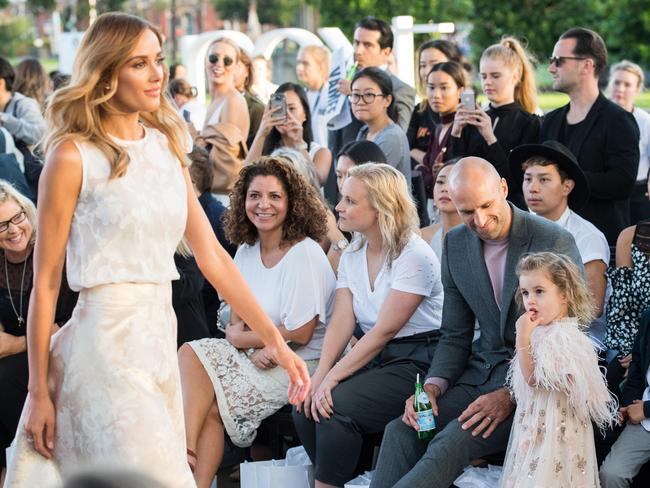 Rebecca Judd models at Melbourne Museum as husband Chris and children Billie and Oscar watch on. Picture: Stuart Walmsley
